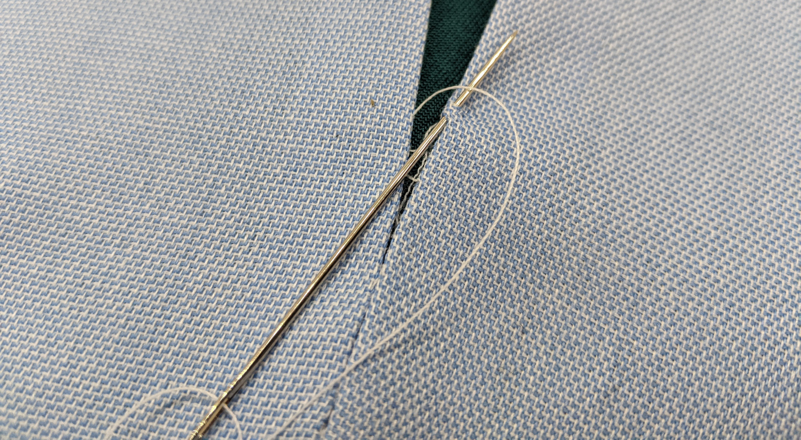 A closeup of a slipstitch being made on a seam