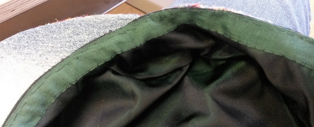 Both edges of the tape are slip stitched, and the edge of the cap is top stitched